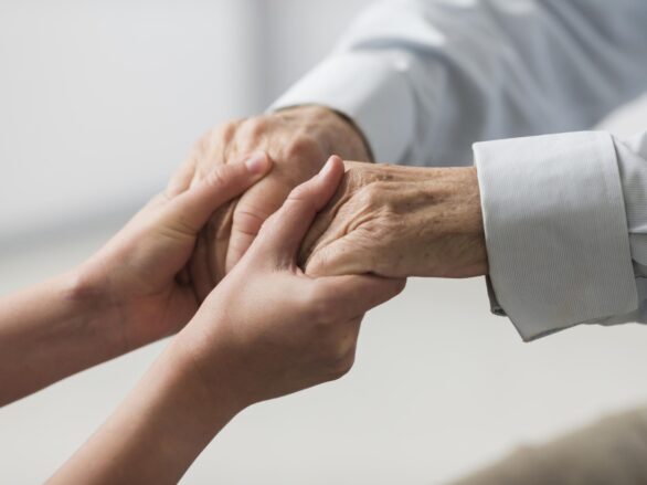 nurse-holding-senior-man-s-hands-sympathy