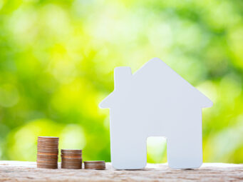 World Habitat Day,close up picture of a pile of coins and a mode